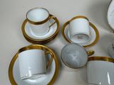 a lot of cups and saucers sitting on a table