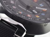 a close up of a watch with a black strap
