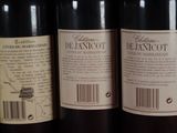 several bottles of wine are lined up on a shelf