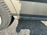 a close up of a car ' s tire on a gravel road