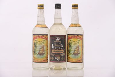 three bottles of alcohol sitting next to each other on a table