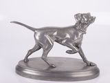 statue of a dog running on a base on a white background
