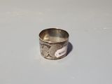 a silver ring that is sitting on a table