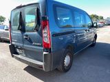 a blue van that is parked in a parking lot