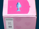 a pink box that has a blue bird on top of it