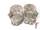 pair of upholstered chairs with floral upholstered covers on them