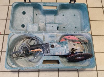 a blue tool box with tools in it on a tiled floor