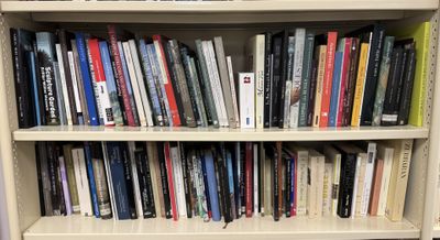 a book shelf with many books on it in a room