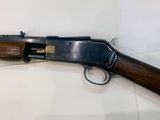 a shotgun that is on display in a glass case