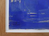 blue and white abstract painting with a wooden frame on a wall