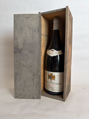 a bottle of wine in a wooden box on a table