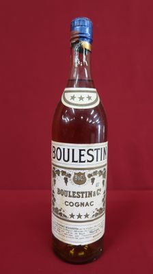 a bottle of bourbon sitting on top of a red table