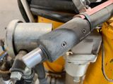 a close up of a machine with a hose attached to it