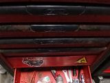a red tool box with tools in it on the floor