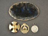 a small metal object with a medal and a medal on it