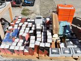 many boxes of cigarettes on a pallet on the ground