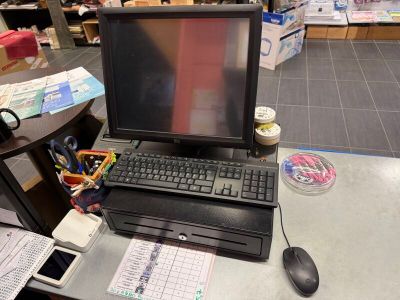 a laptop computer sitting on top of a desk in a store