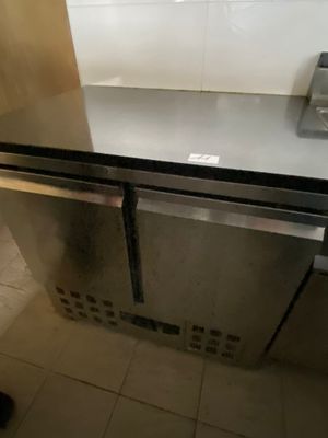 a stainless steel refrigerator in the corner of a kitchen
