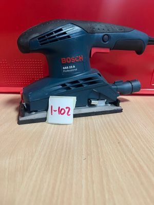 une ponceuse orbitale Bosch posée sur une table, avec son étiquette de prix