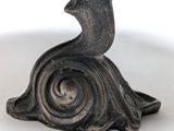 a silver plate with a bird on it on a stand