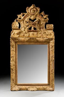 an ornately carved gold mirror with a bird on it