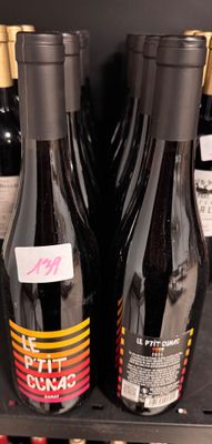 several bottles of wine are on a shelf in a store