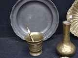 several pieces of brass are displayed on a black surface