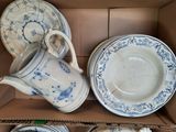 a box with a bunch of plates and cups in it
