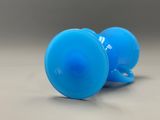 a blue plastic object that is on a table