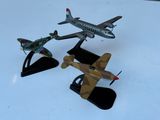 two model airplanes on display on a white surface