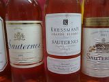 several bottles of wine are lined up in a row on a table