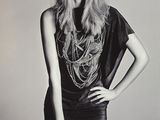 black and white photograph of a woman in short shorts and a t - shirt