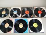 several different types of vinyl records are lined up on a table