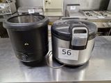 two electric pots sitting on a table in a kitchen