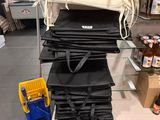 many bags of food on a cart in a store
