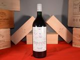 a bottle of wine sitting on a table next to wooden boxes
