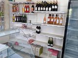 bottles of alcohol are on display in a store with shelves full of bottles