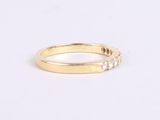 a close up of a gold ring with three diamonds on it