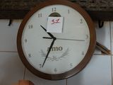 a clock that is hanging on the wall with a note attached to it