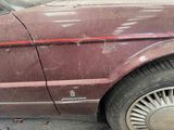 a red line on the side of a maroon car