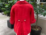 a picture of a red coat on a mannequin stand