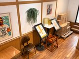 a room with a desk, chairs, and pictures on the wall