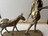 bronze figurine of a man with a horse and a cart