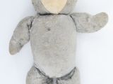 a teddy bear that is laying down on a white surface