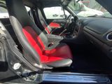 a picture of the interior of a car with red and black seats