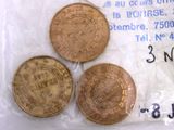 three coins in a plastic bag with a price tag on it