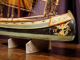 a wooden model of a boat on a table