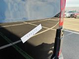a sticker on the back of a van that is parked in a parking lot