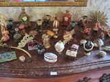 many figurines on a dresser with a mirror in the background