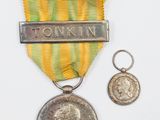 une image représentant une médaille sur laquelle figure une autre médaille, et une médaille sur laquelle figure une autre médaille